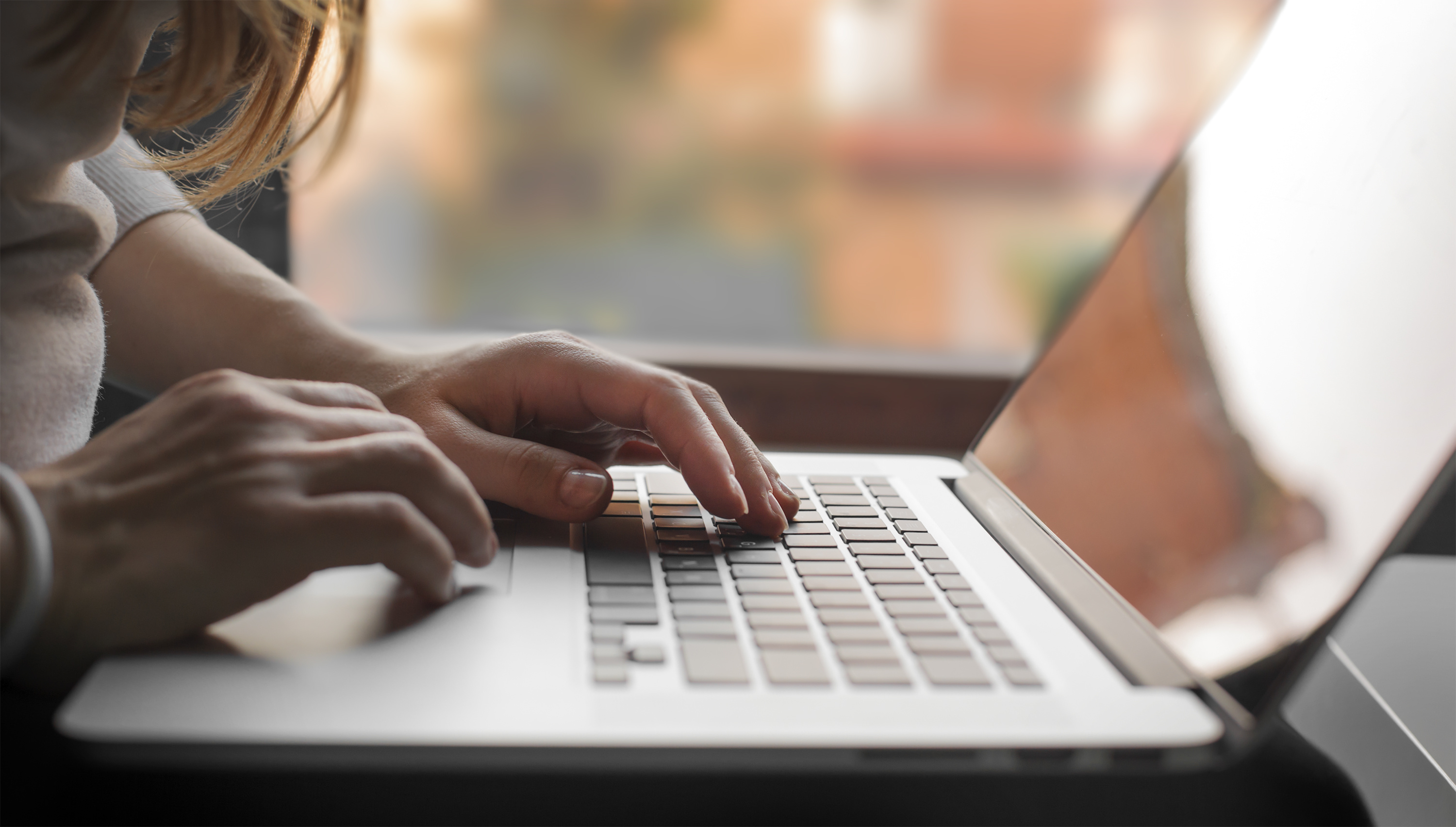 hands on laptop keyboard