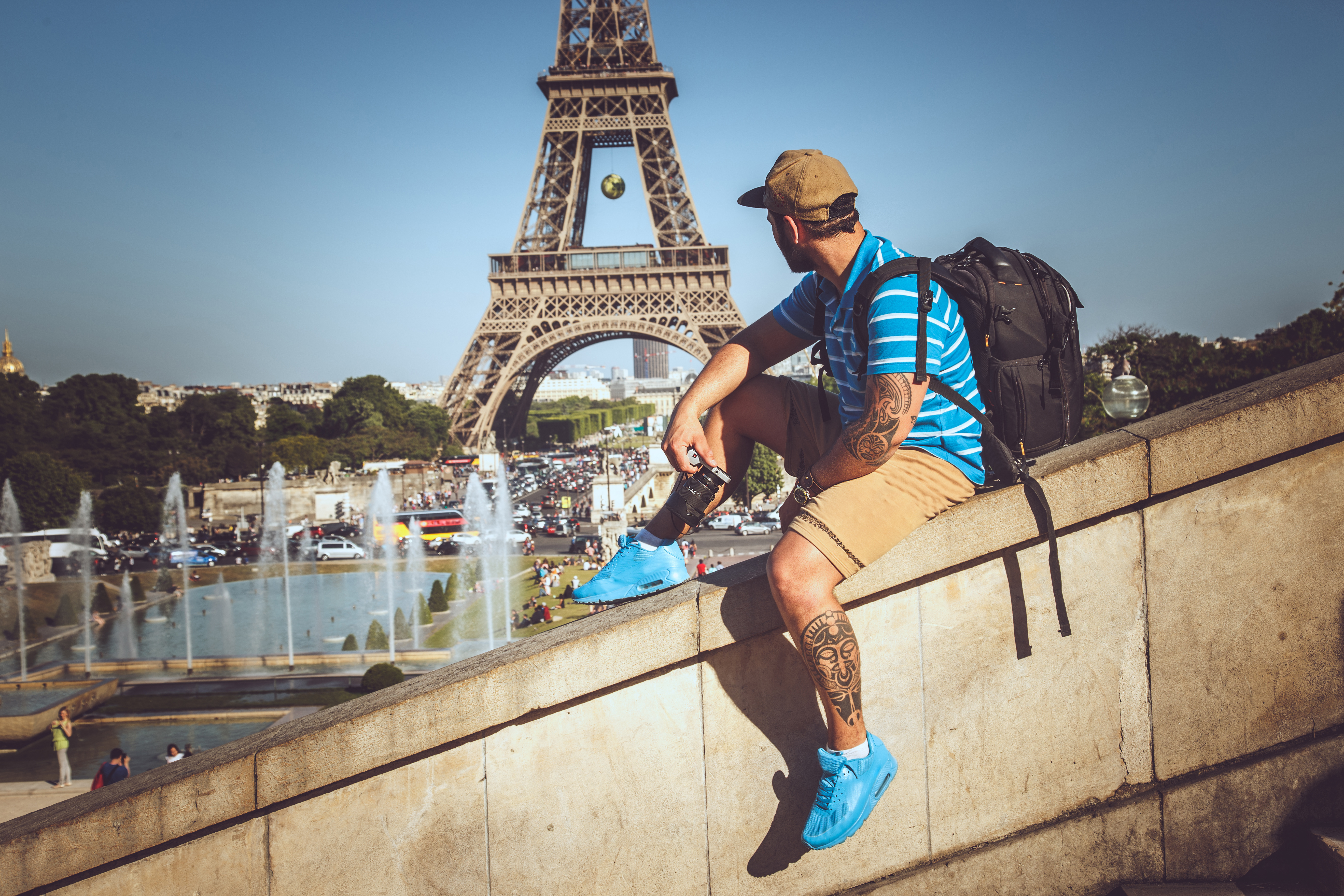 man sitting near Eiffel tower
